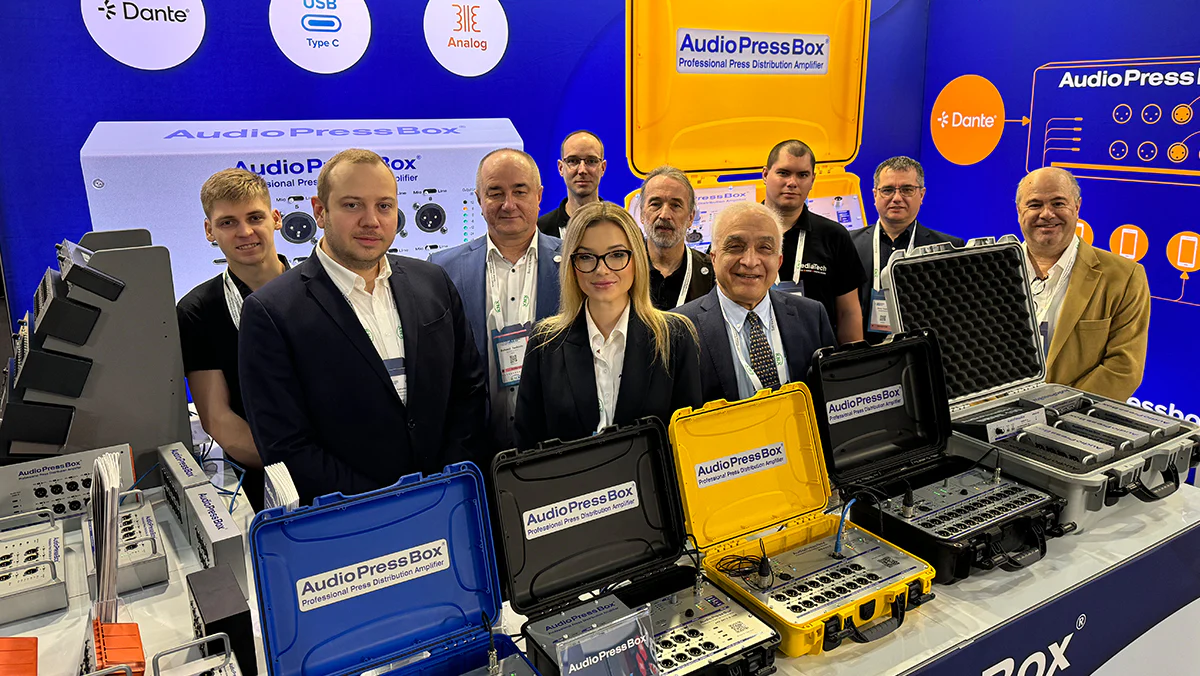 AudioPressBox team and partners at trade show booth — press boxes on display for media audio distribution