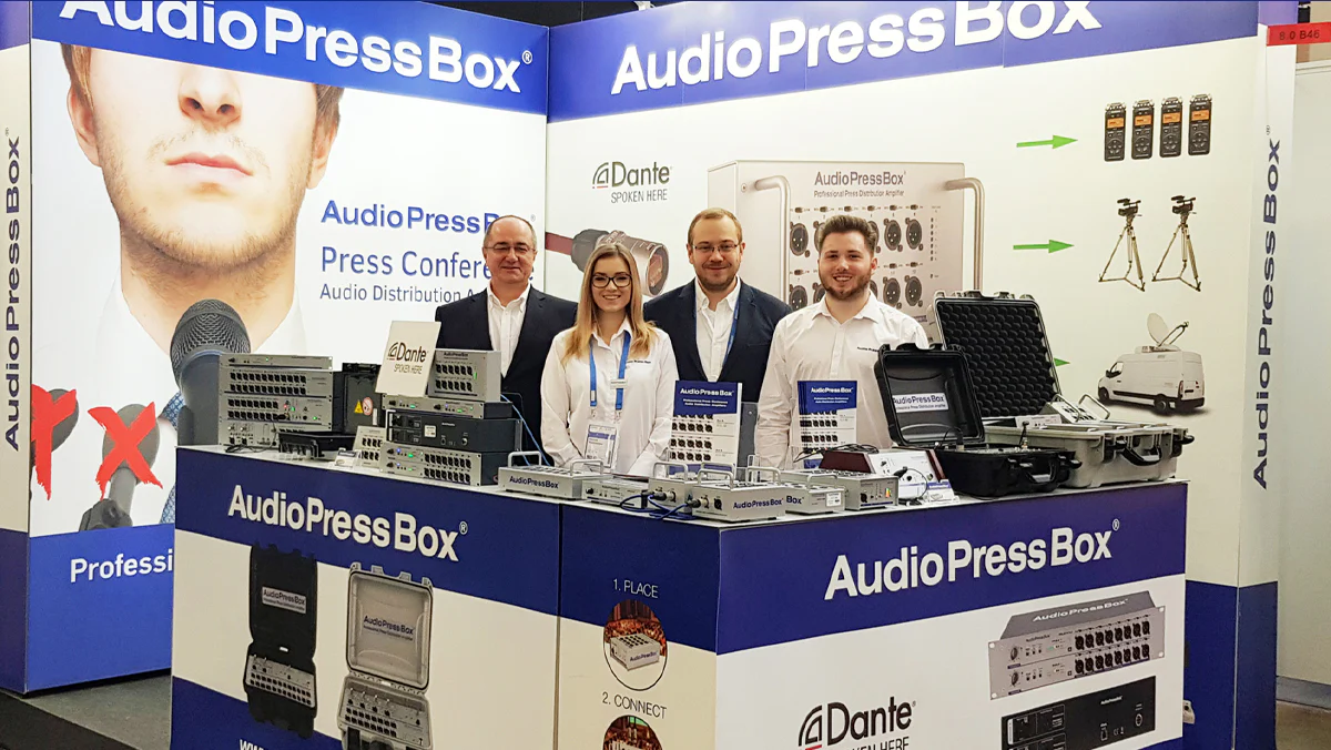 ISE 2022 - AudioPressBox team at trade show booth — press boxes on display for media audio distribution