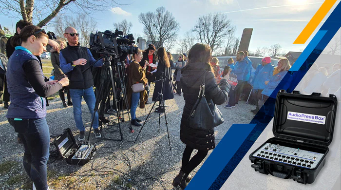Media briefing outdoors — AudioPressBox APB 224-C used for press audio distribution