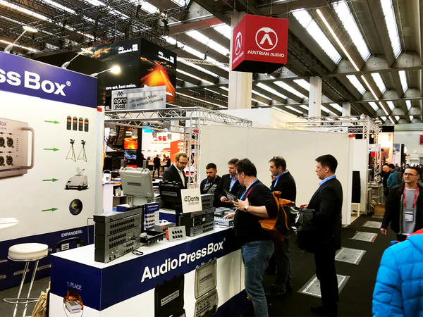 PL+S 2019 - AudioPressBox trade show booth demonstration — visitors discussing press box audio distribution
