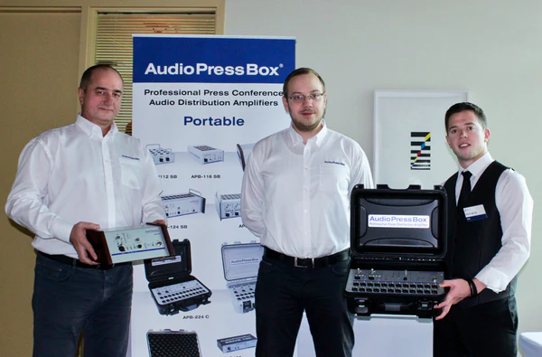AudioPressBox at SFM in Canada - AudioPressBox team at trade show booth — press boxes on display for media audio distribution