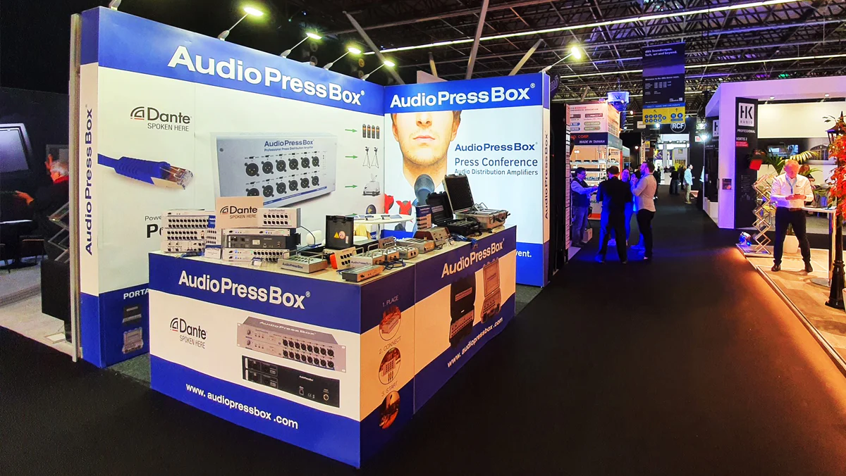 AudioPressBox at Infocomm 2022 - AudioPressBox trade show booth demonstration — visitors discussing press box audio distribution