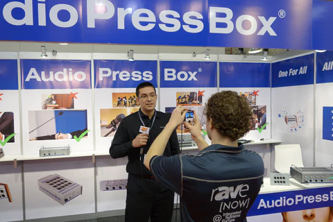 ISE 2014 - AudioPressBox trade show booth demonstration — visitors discussing press box audio distribution